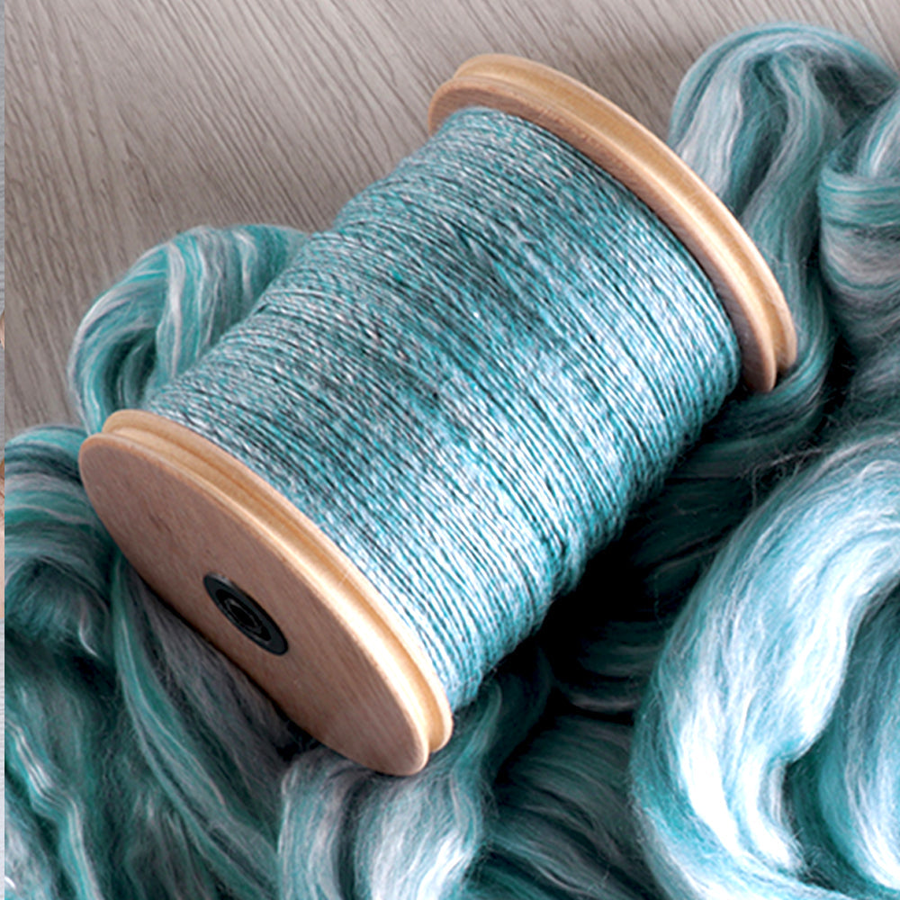 Spinning bobbin with pulley filled with blue handspun yarn – Tisse et File spinning accessories collection