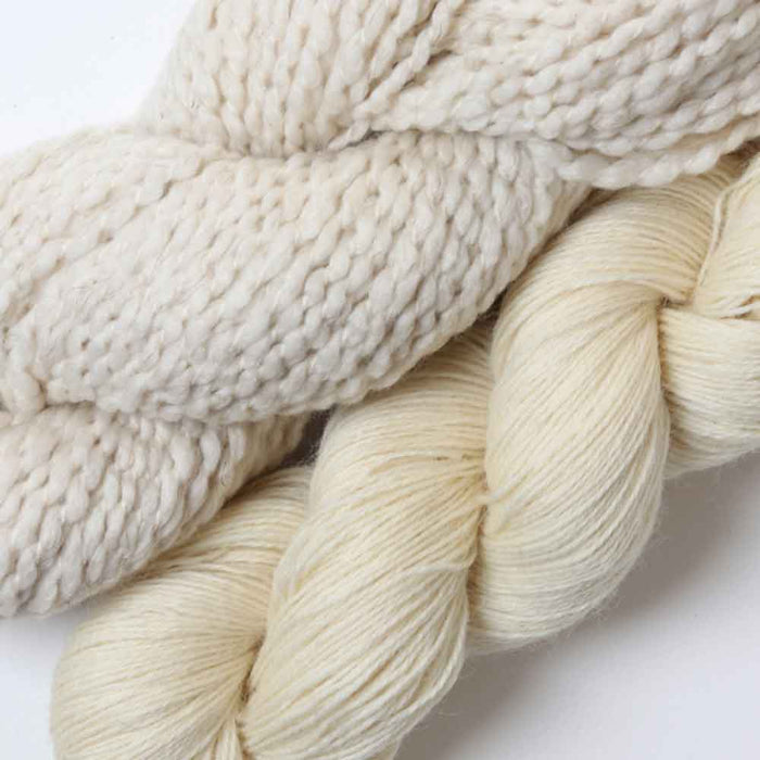 Ashford Weaving Kit 1 – close-up of undyed Merino/Viscose/Linen chunky yarn and 4 ply New Zealand wool skeins included in the Lattice Scarf kit.