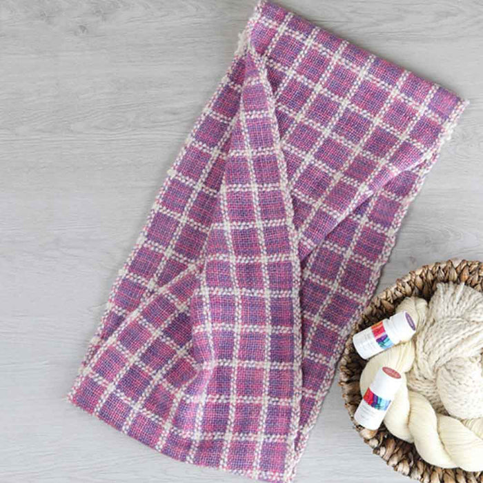 Ashford Weaving Kit 1 – dyed version of the Lattice Scarf in pink and violet tones, woven with Ashford Merino/Viscose/Linen and Wool yarns using Ashford Protein Dyes.
