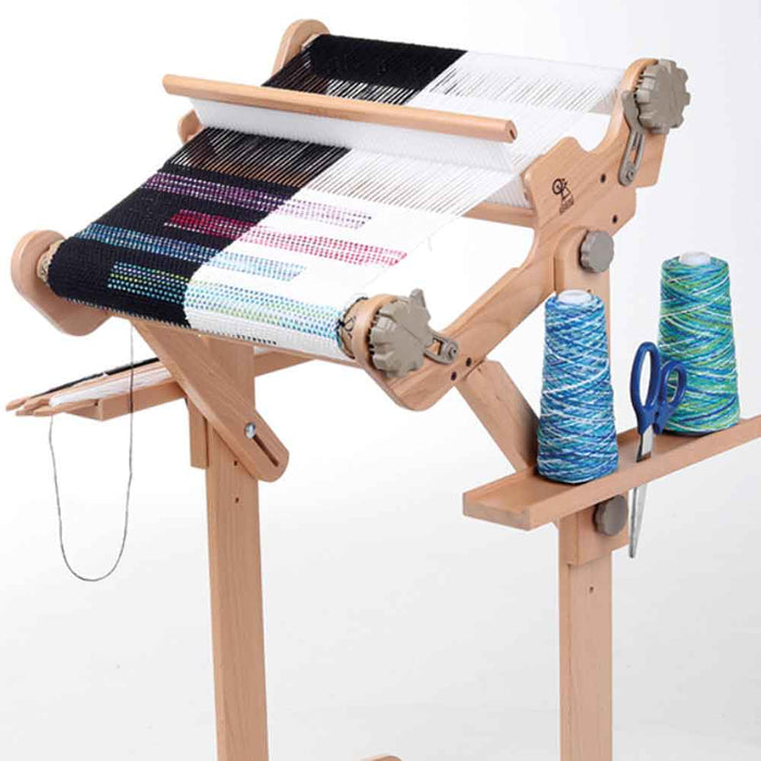 Ashford loom stand accessory trays holding yarn cones and scissors on rigid heddle loom stand