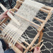 Student weaving a first scarf during a beginner rigid heddle weaving workshop at Tisse et File