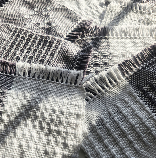 Collection of woven samples created using two rigid heddles and a pickup stick on a rigid heddle loom