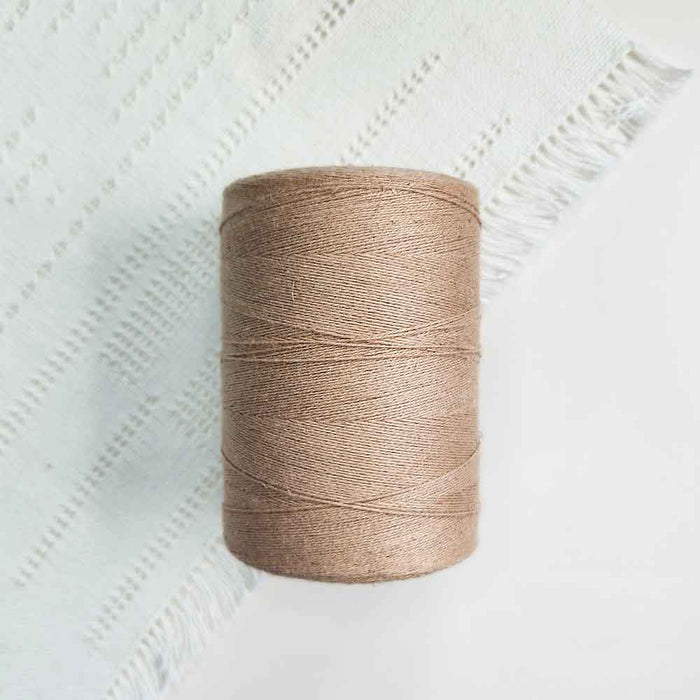 Cone of beige cotolin weaving yarn by Brassard