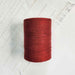 Cone of brick cotolin weaving yarn by Brassard