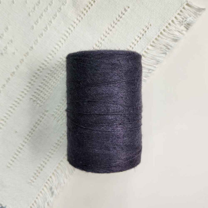 Cone of charcoal cotolin weaving yarn by Brassard