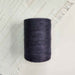 Cone of charcoal cotolin weaving yarn by Brassard
