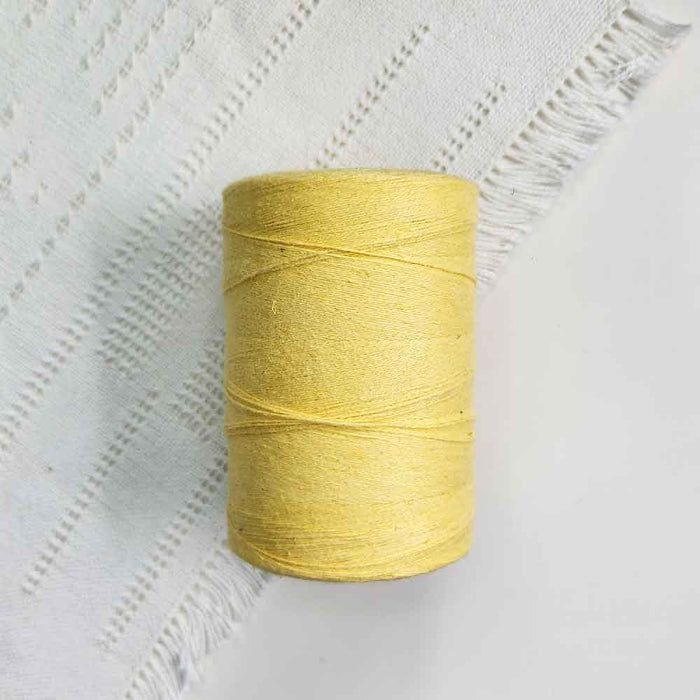 Cone of jaune fonce cotolin weaving yarn by Brassard