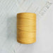 Cone of jaune or cotolin weaving yarn by Brassard