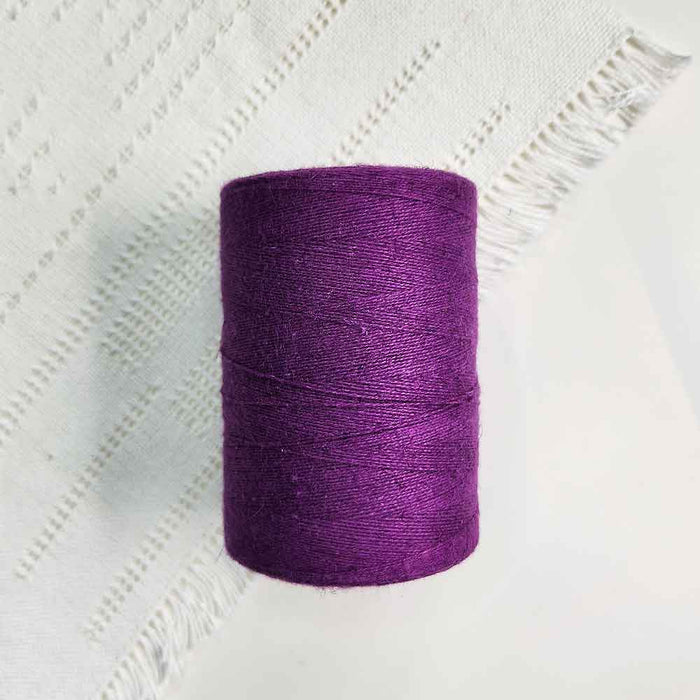 Cone of mauve cotolin weaving yarn by Brassard