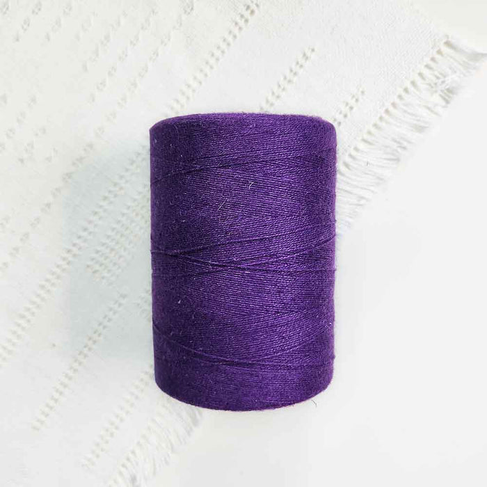 Cone of mauve cotolin weaving yarn by Brassard