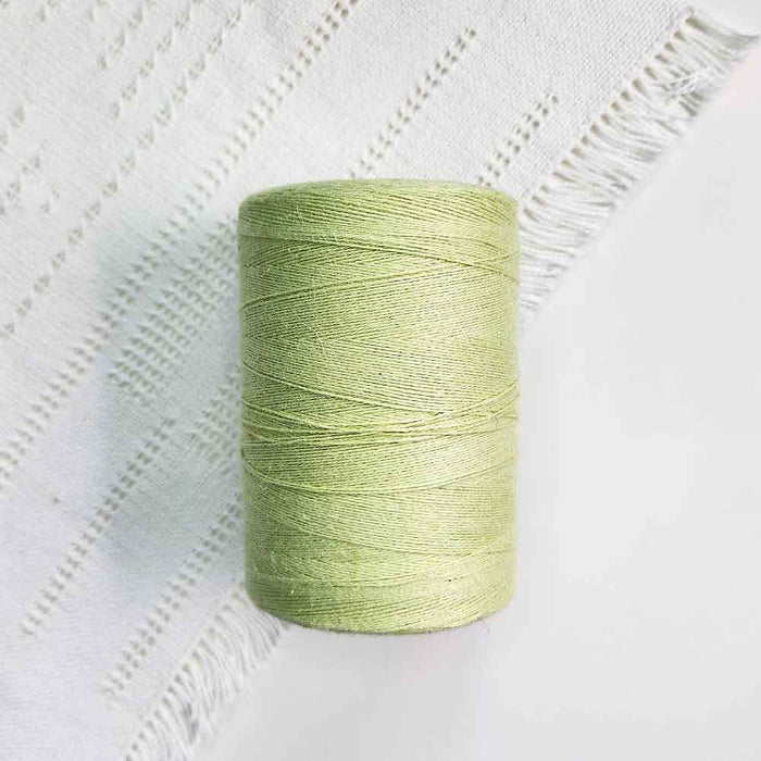 Cone of nil green cotolin weaving yarn by Brassard
