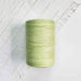 Cone of nil green cotolin weaving yarn by Brassard