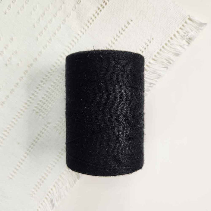 Cone of noir cotolin weaving yarn by Brassard