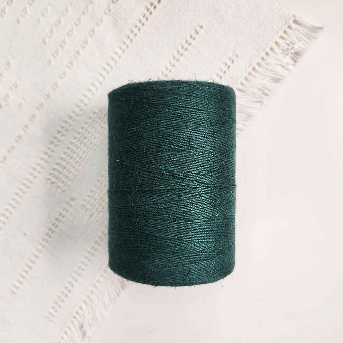 Cone of vert fonce cotolin weaving yarn by Brassard