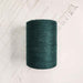 Cone of vert fonce cotolin weaving yarn by Brassard