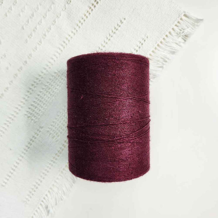 Cone of wine cotolin weaving yarn by Brassard