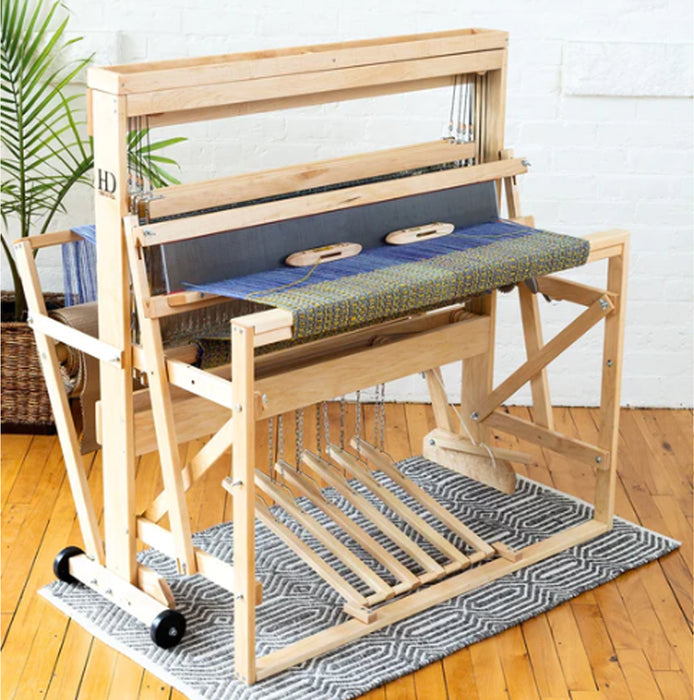 Harrisville Designs 4-shaft floor loom front view with blue fabric on the warp