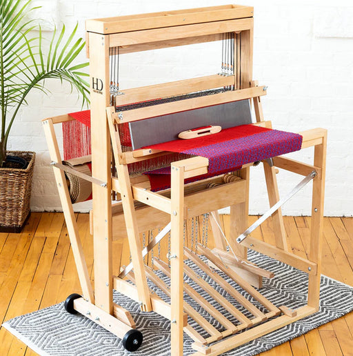 Harrisville Designs 4-shaft floor loom front view with red fabric in progress