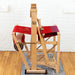 Side view of Harrisville Designs 4-shaft floor loom weaving red cloth