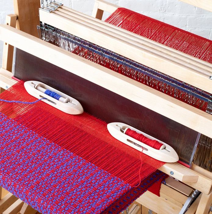 lose-up of front breast beam with fabric advancing on Harrisville Designs floor loom