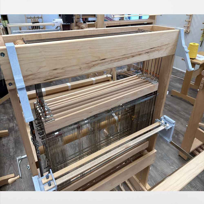 Lofty Fiber Helping Hands holding lease sticks for threading on a Harrisville loom