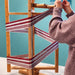 Participant preparing a warp on a rotary warping mill during an indirect warping class at Tisse et File