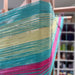 Turquoise, yellow and pink yarn being prepared on a warping mill for indirect warping