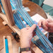 Band weaving in progress on an inkle loom at Tisse et File
