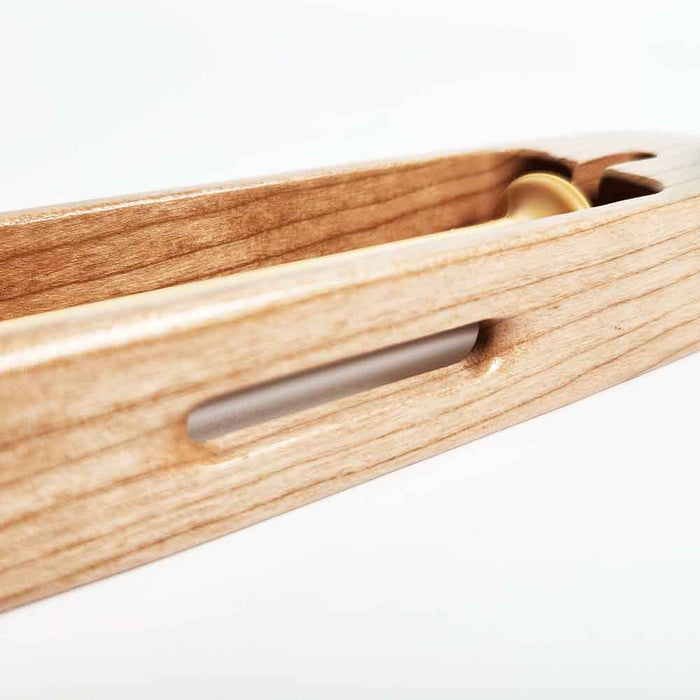 Detail view of Leclerc open-bottom weaving shuttle for compact looms