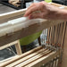Close-up of a Lofty Fiber raddle mounted on a Harrisville Designs loom