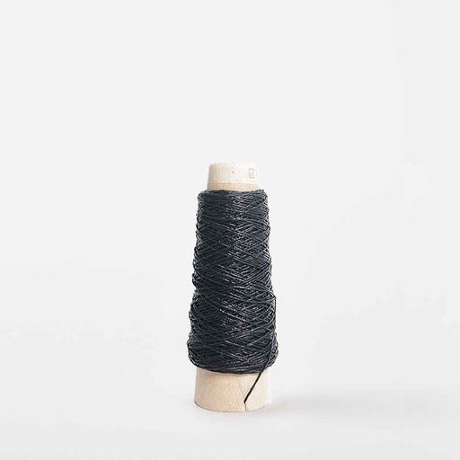 Mondofil Gommina coated yarn cone in black for structured weaving and textile design