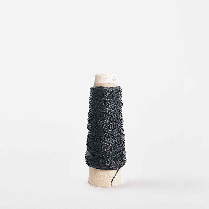 Mondofil Gommina coated yarn cone in black for structured weaving and textile design