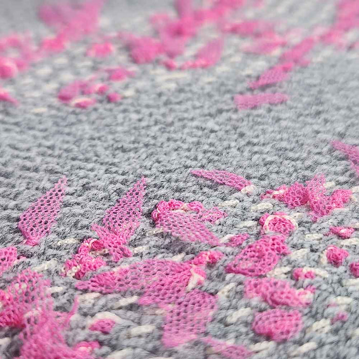 Woven fabric using Mondofil Papiyon yarn showing textured pink accents