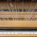 Self-adhesive centering tape installed on a loom beater for accurate warp alignment.