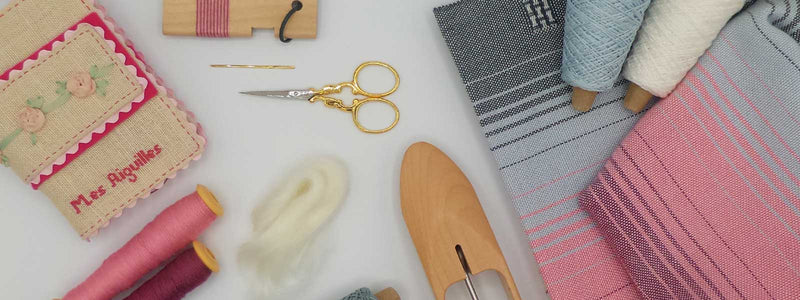 Weaving and spinning tools including yarn, shuttles and handmade textiles at Tisse et File, a Canadian weaving supplies shop.
