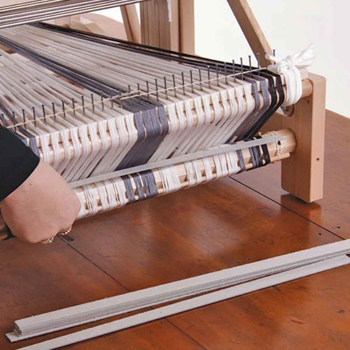warp sticks installed on table loom