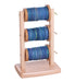 Ashford spinning wheel lazy kate with multiple bobbins filled with yarn