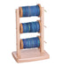 Ashford spinning wheel lazy kate with multiple bobbins filled with yarn